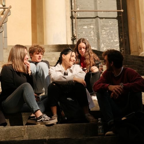 a group of people sitting on the steps of a building